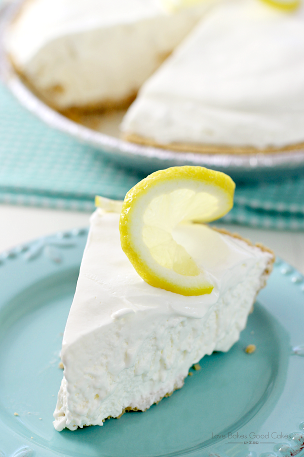 Tarta de limonada congelada en un plato azul con una rodaja de limón.